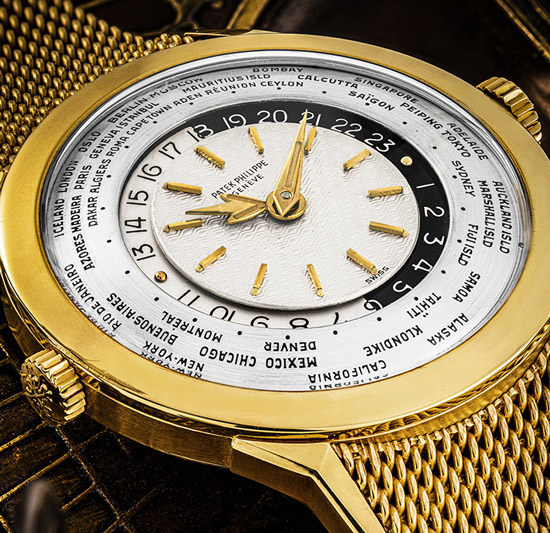 PATEK PHILIPPE. AN EXTREMELY FINE, UNIQUE AND IMPORTANT 18K GOLD TWO CROWN WORLD TIME WRISTWATCH WITH 24 HOURS INDICATION, GUILLOCHÉ SILVERED DIAL, LUMINOUS HANDS AND GOLD BRACELET REF. 2523/1